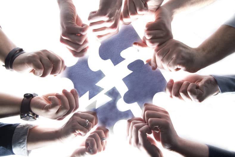 Team effort to solve a jigsaw puzzle.