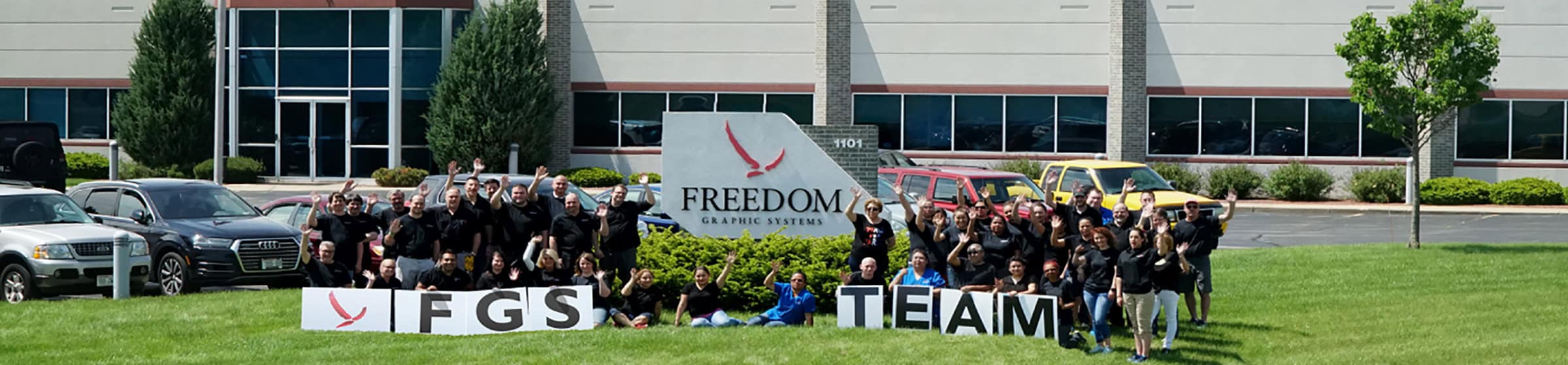 FGS team pictured outside on a sunny day, in front of the facility.