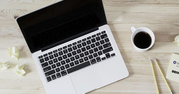 laptop and coffee cup on a desk