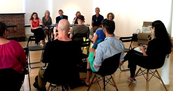 photo of people siting in chairs at an event