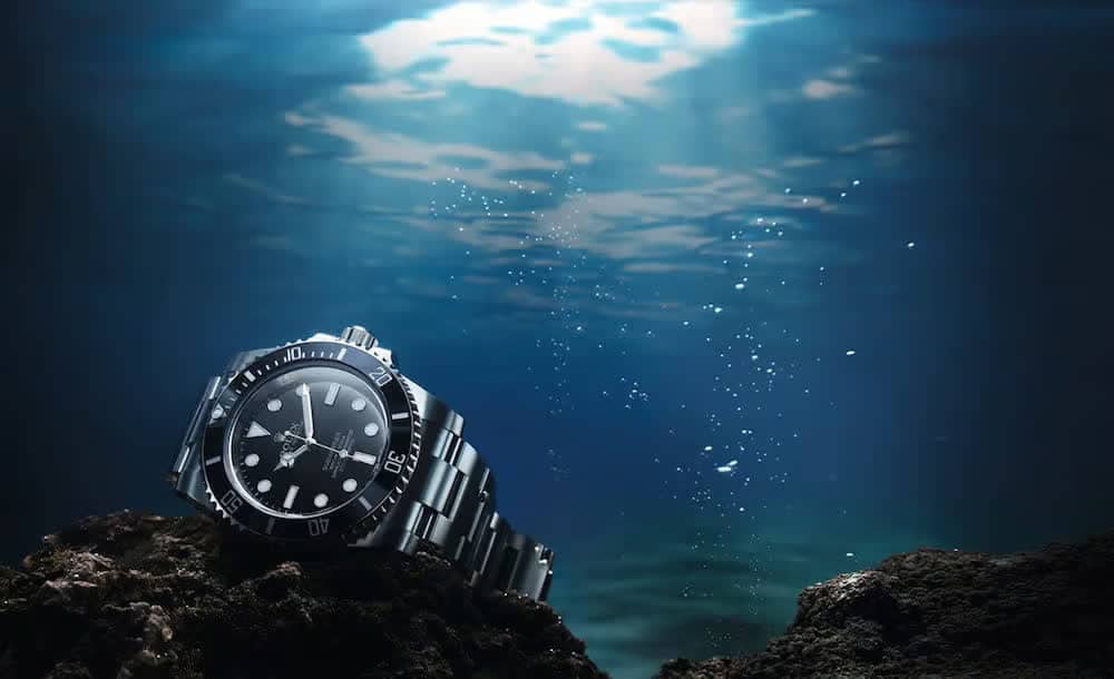 Rolex Submariner steel dive watch underwater on rocks