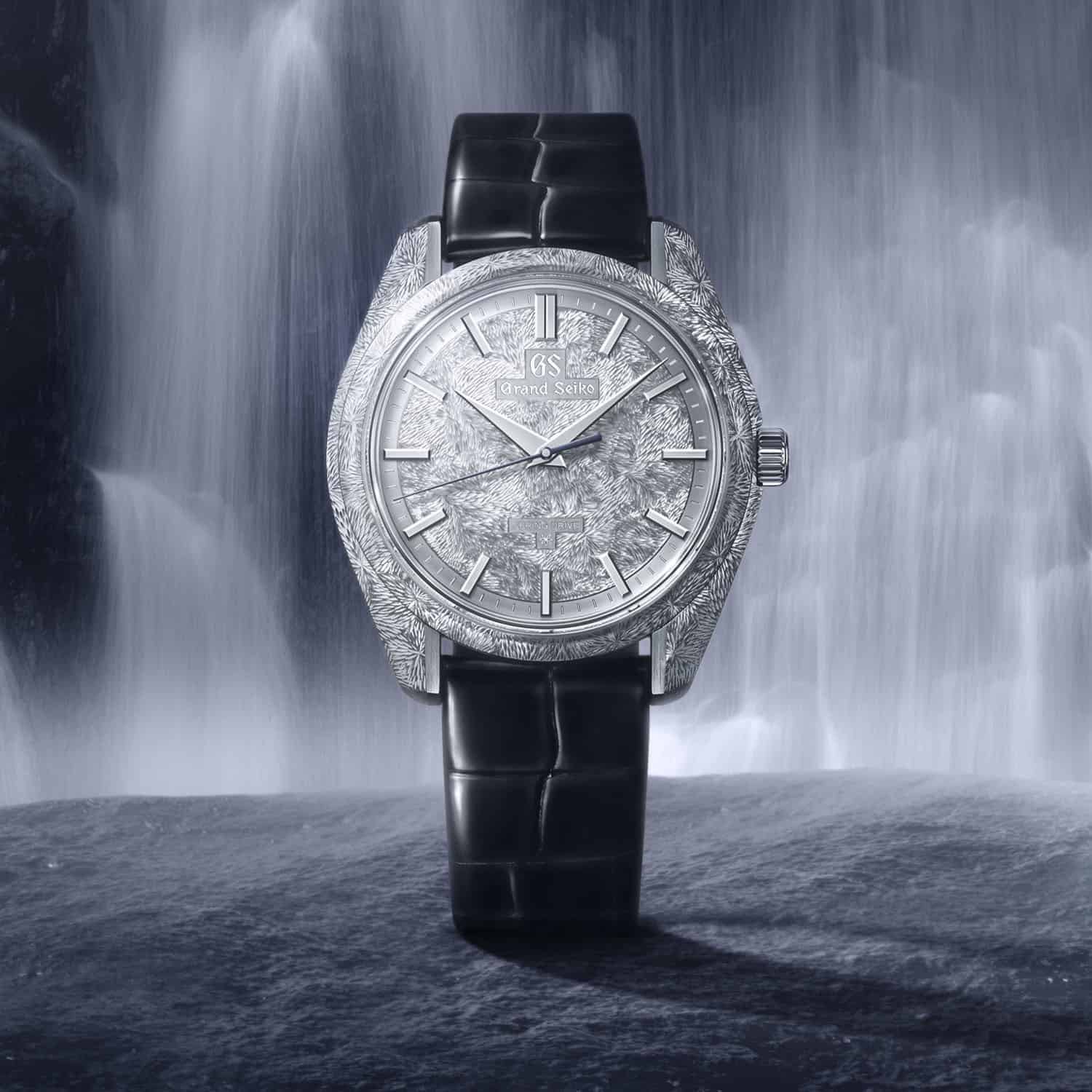 Grand Seiko Masterpiece Collection SBGZ011 Mystic Waterfall hand-engraved platinum watch against a waterfall backdrop