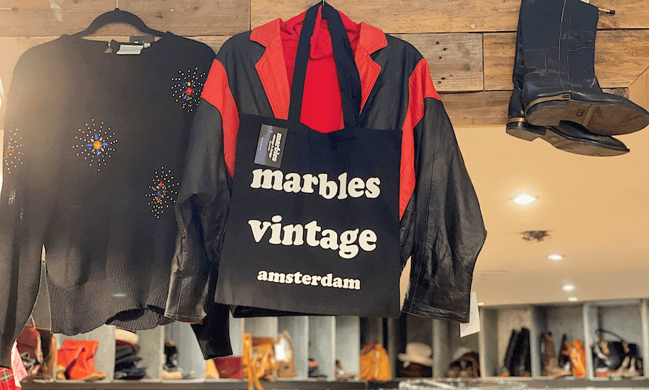 Black Marbels Vintage Amsterdam fabric bag hanging next to jumper and boots