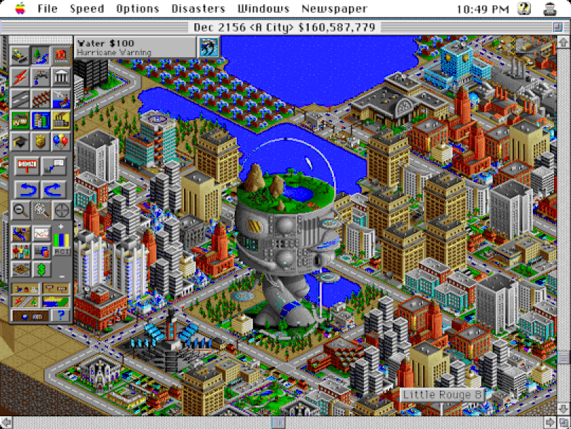 A screenshot of gameplay in SimCity 2000, with a large arboretum in the centre of a sprawling city, and a large body of water at the top of the screen.