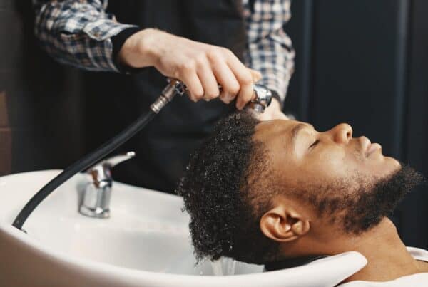 man washing hair with hard water