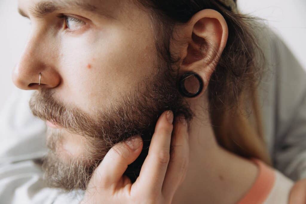 a man considering using his beard hair for a hair transplant