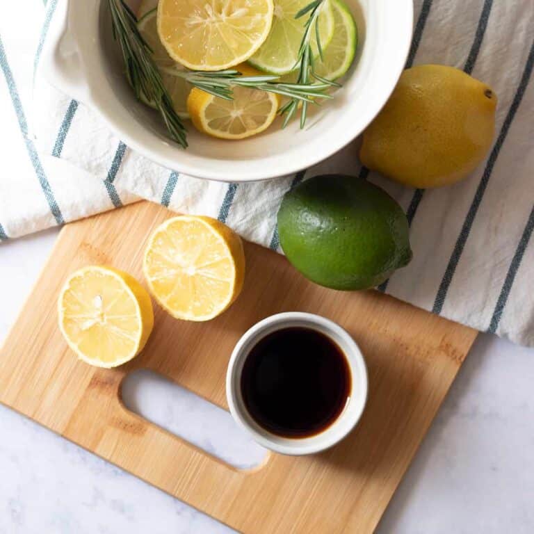 DIY Citrus Summer Stove Top Potpourri Ingredients on a bamboo cutting board and inside a mason cash bowl