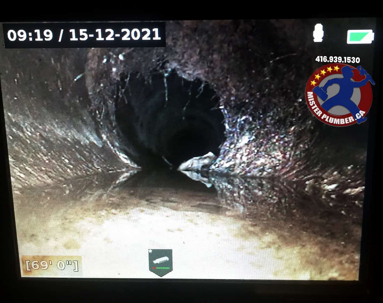Sewer camera shows roots growing inside the pipe through the crack
