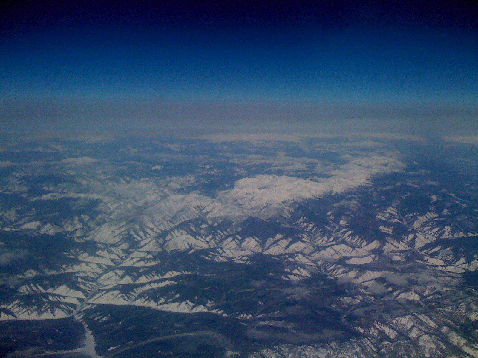 Shanghai maglev Transrapid train speeding past with modern city buildings in the background