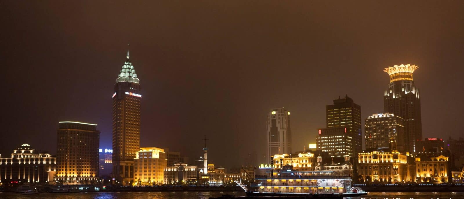 Shanghai skyline viewed from the Bund with historic waterfront buildings and modern skyscrapers across the river