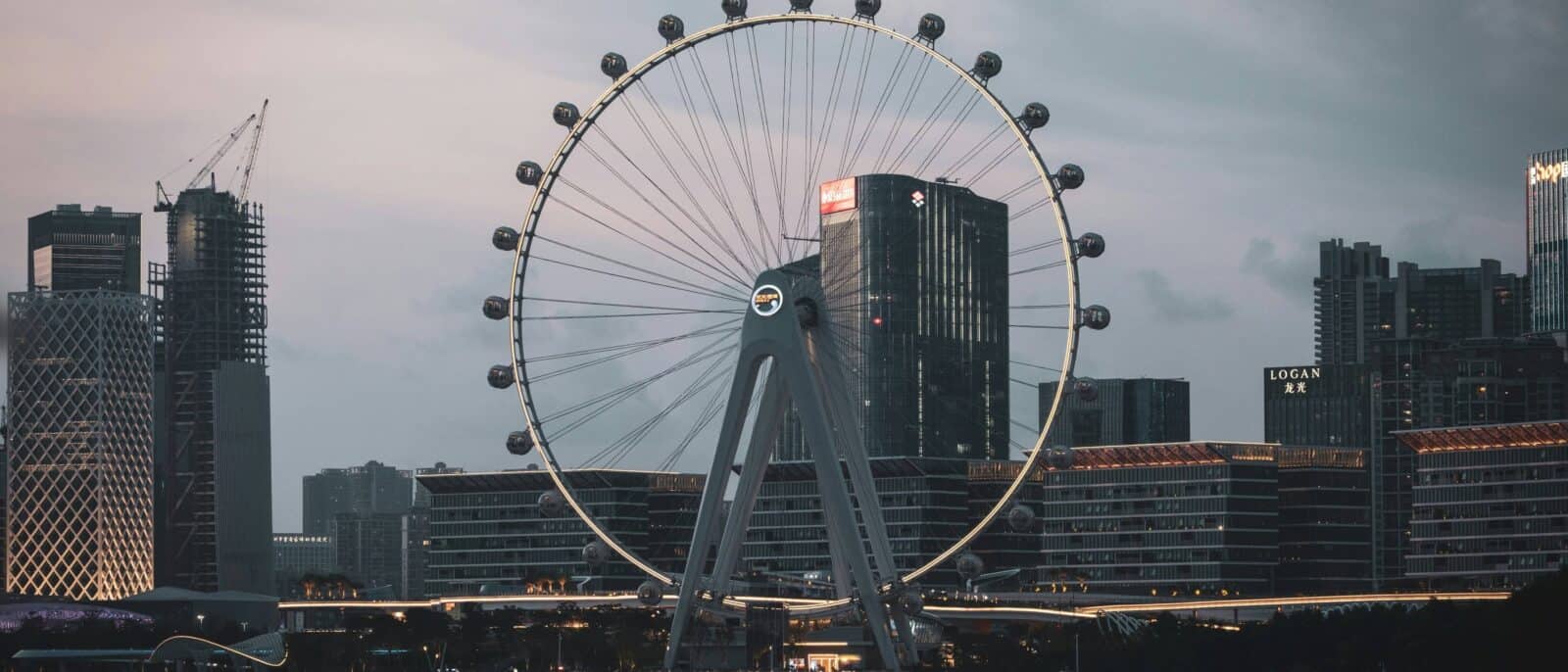 Family with young children at Shenzhen airport, looking out at planes and waving goodbye to China