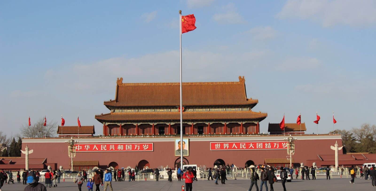 Children exploring the Forbidden City in Beijing with their parents, looking at red palace walls and golden roofs