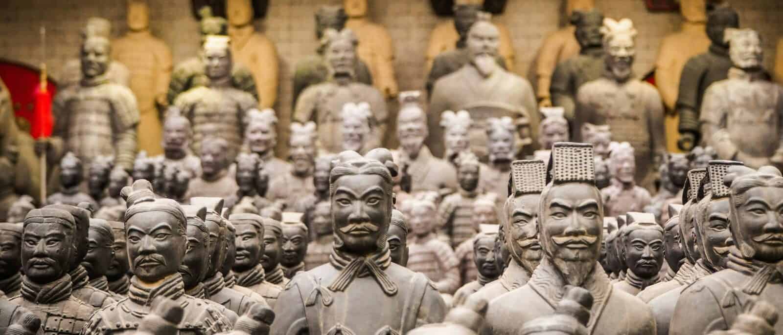 Children looking at rows of life-size clay soldiers in the Terracotta Army museum near Xi’an