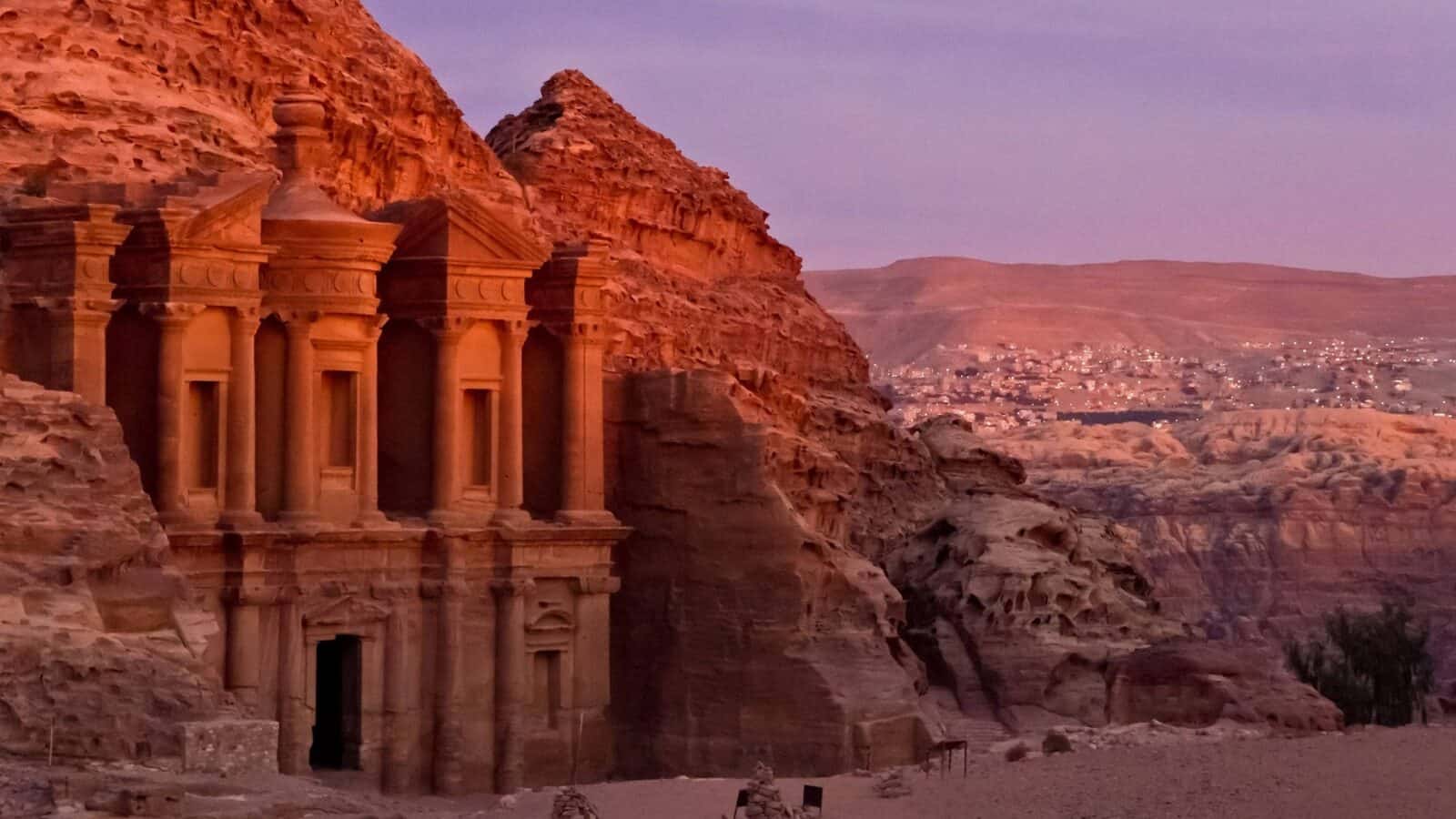 Narrow sandstone gorge opening onto the Treasury in Petra, Jordan, lit by soft daylight
