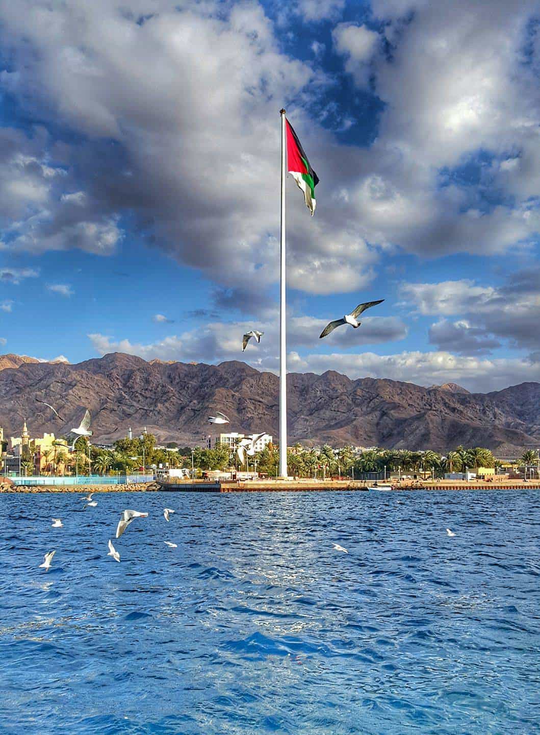 Turquoise waters of the Red Sea near Aqaba with coral reef and boats on a sunny day