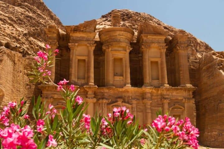 Panoramic view of Jordan’s desert landscape with red sand, rugged rock formations and clear blue sky near Wadi Rum