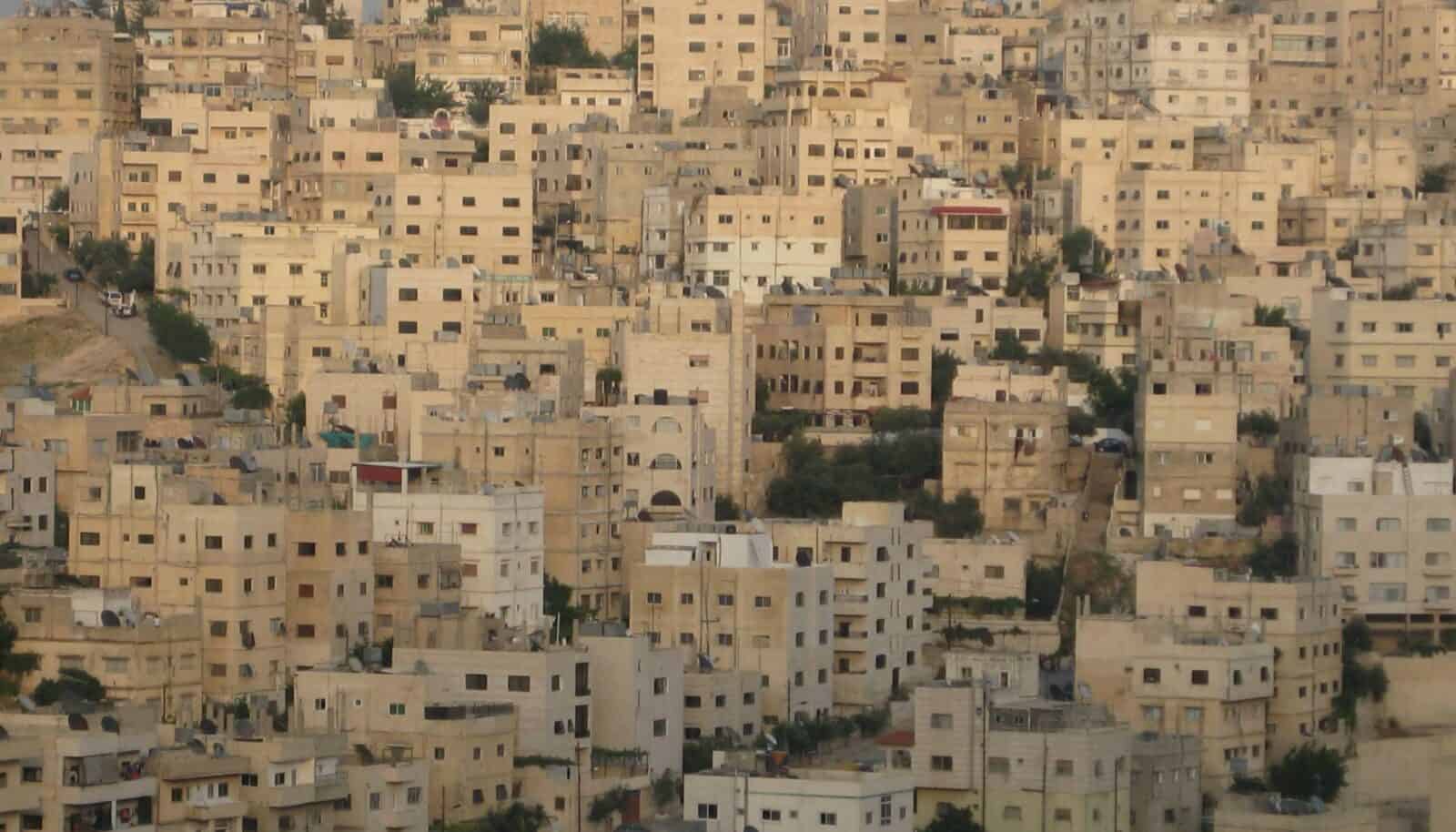 View over the city of Amman with hillside buildings under a clear sky