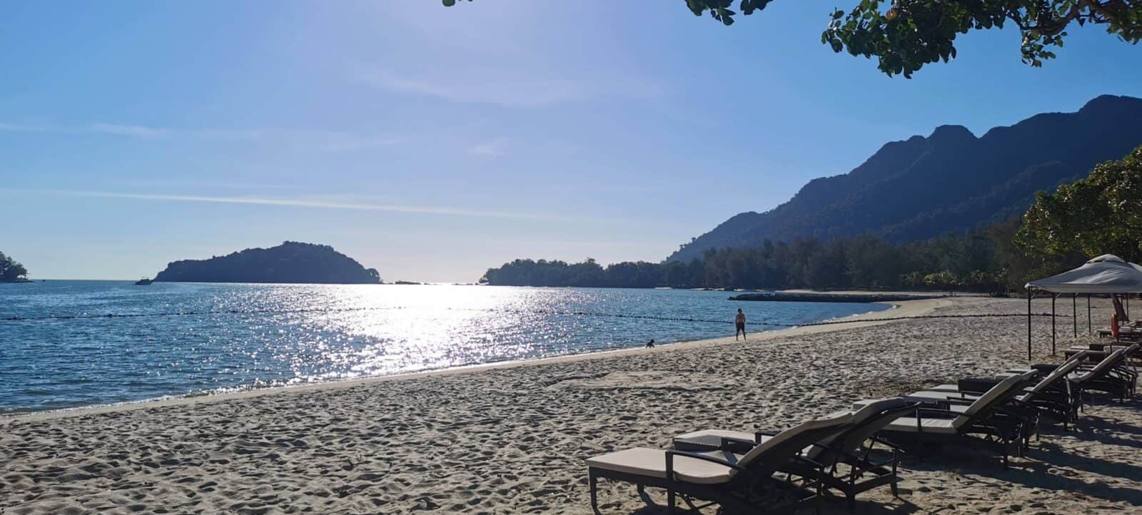 Palm-fringed beach in Langkawi with white sand and clear turquoise water
