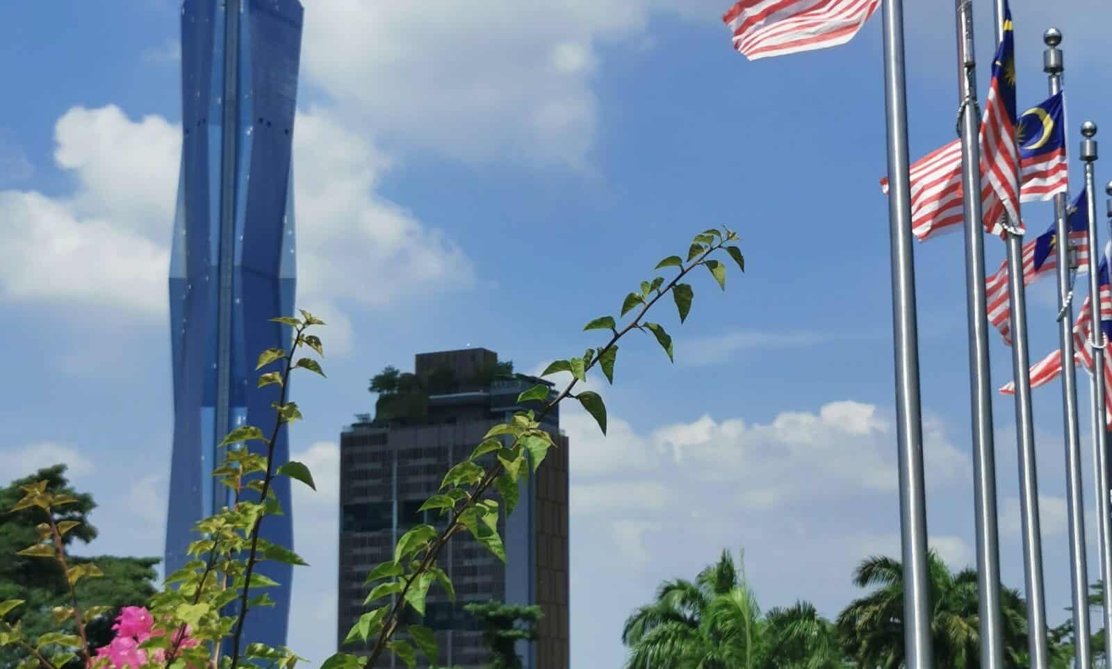 Tourists walking through Kuala Lumpur Chinatown near Central Market and colourful shopfronts