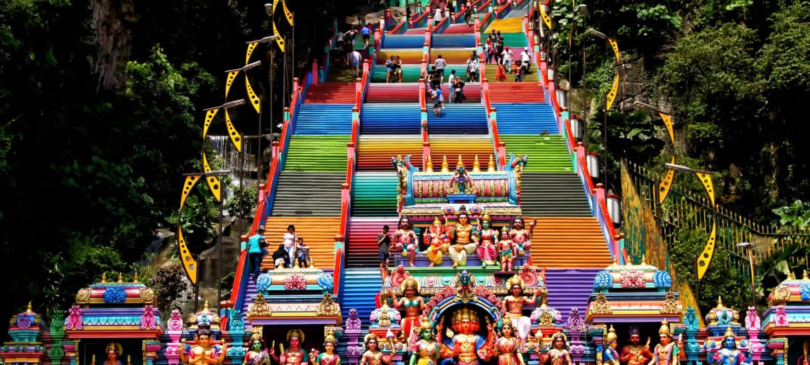 Steep staircase and golden Lord Murugan statue at Batu Caves in Malaysia