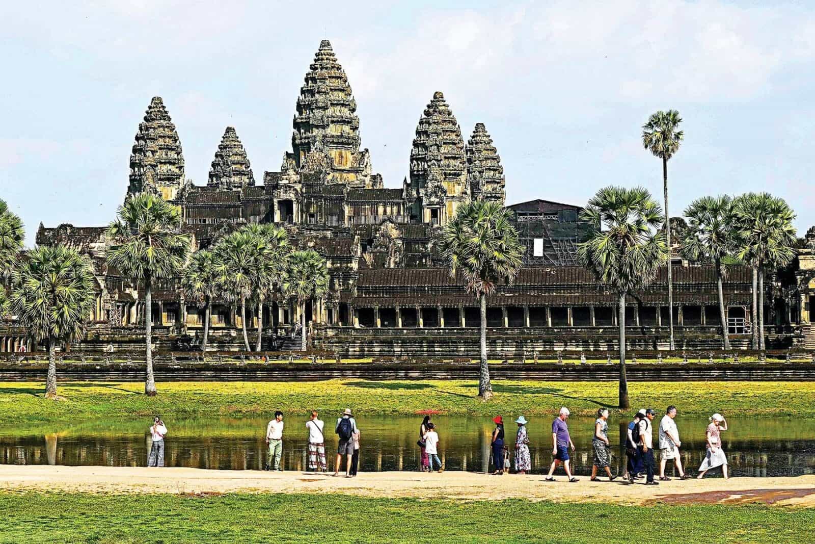 Traveler with luggage walking through Siem Reap International Airport departure hall