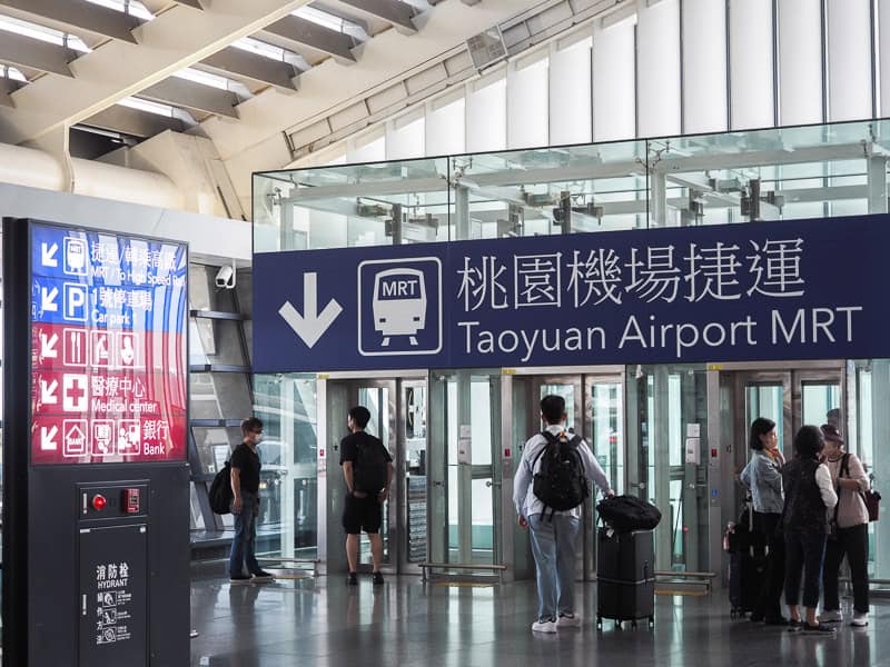 A large sign that says "Taoyuan Airport MRT" and points down