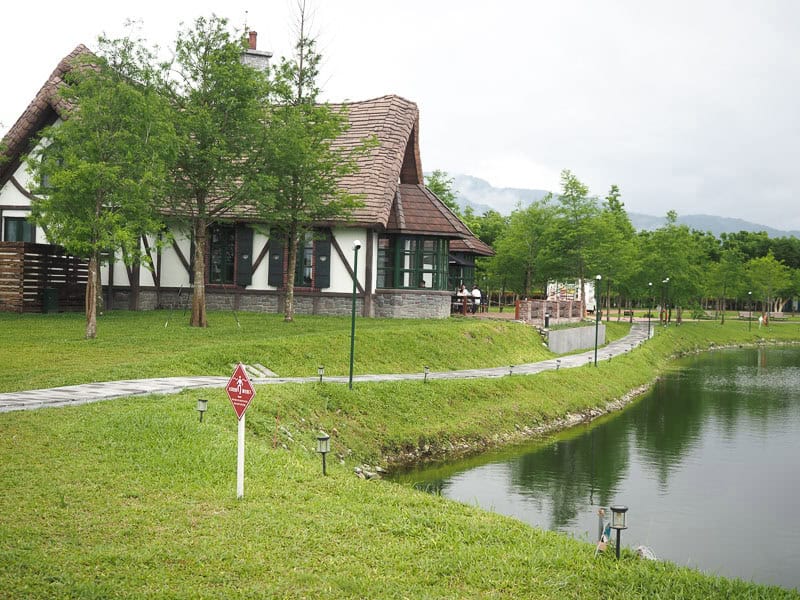 The side of a Starbucks looking over a lake with walking path in front