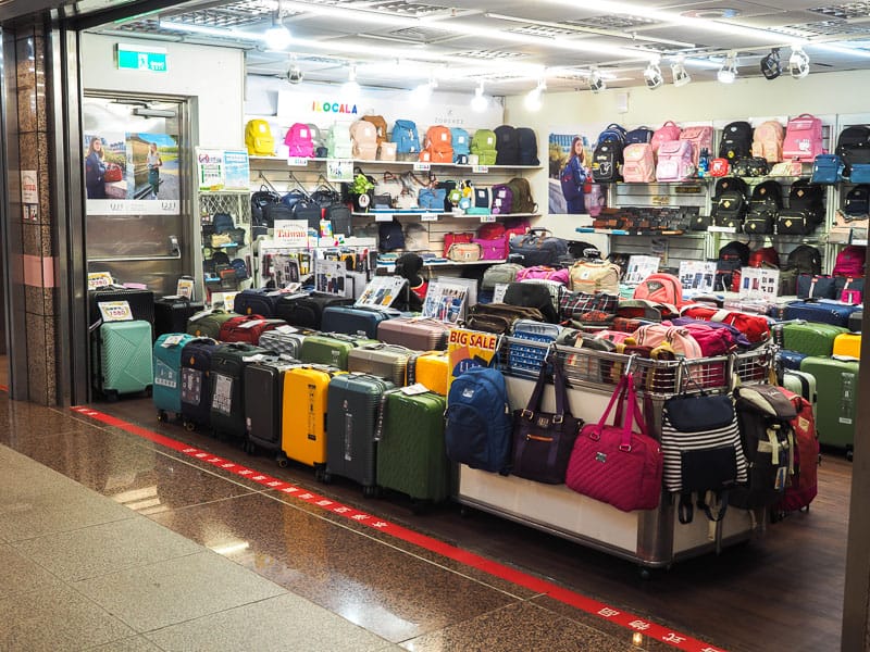 A luggage shop with many travel luggages on display