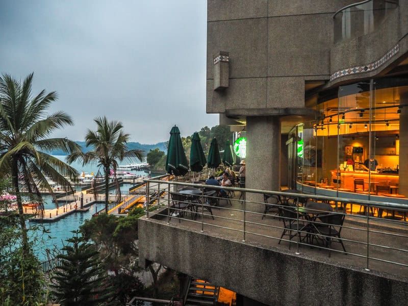 Cement Starbucks building with view of docks on Sun Moon Lake