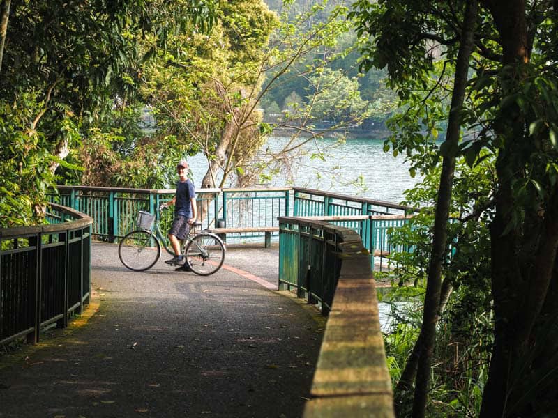 Nick Kembel on a bike on a lakeside path at Sun Moon Lake