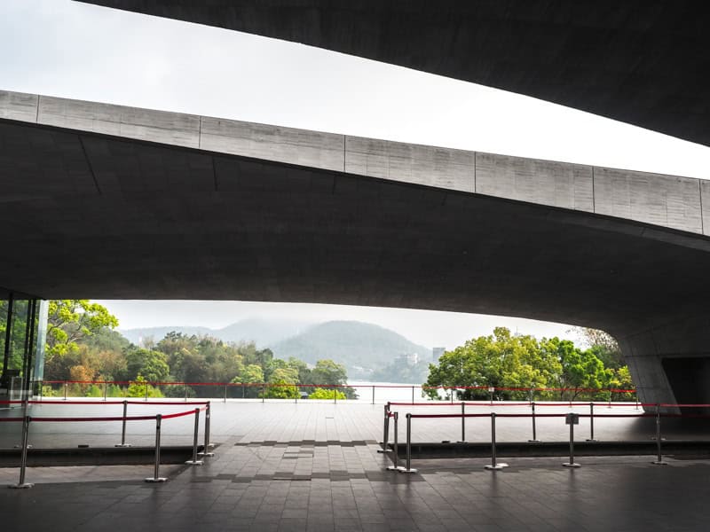 Looking out from under two large cement beams of Xiangshan Visitor's Center at Sun Moon Lake