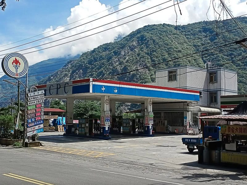A CPC gas station in Taiwan with mountains behind and cloudy sky above