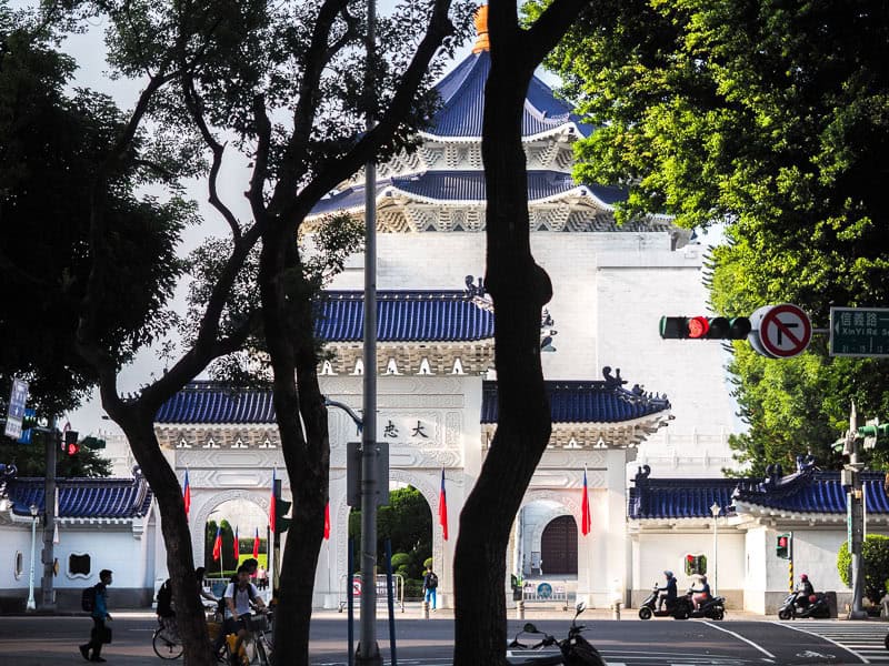 Daxiao gate and the top of CKS Memorial Hall, shot from down the road, with some trees in silhouette in front of it