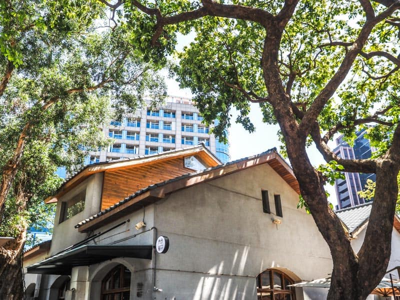 The upper half of Daylight Restaurant in Huashan, in an old warehouse building, with large tree growing beside it