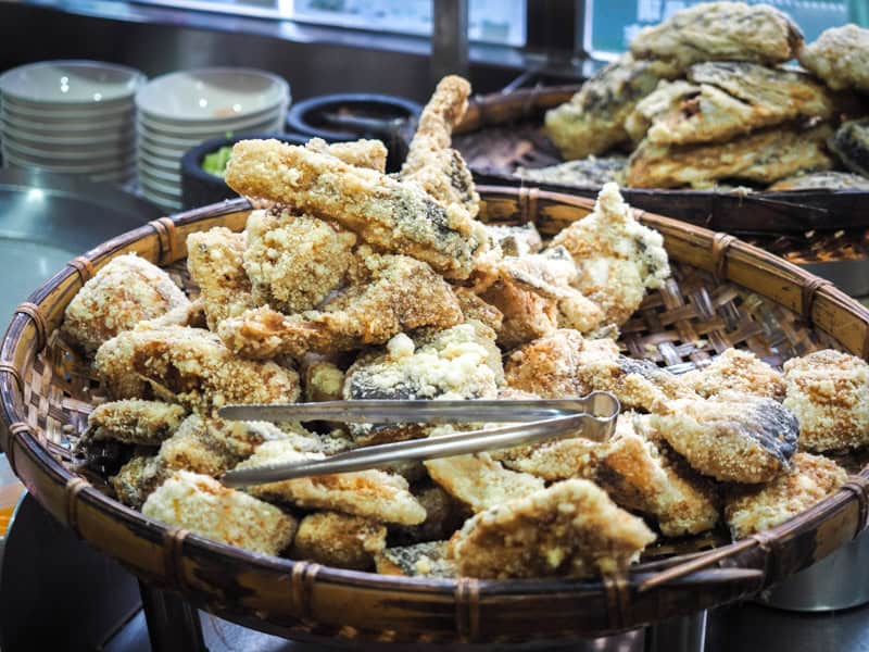 A large basket filled with battered and deep fried fish heads