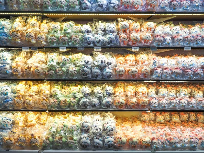 Several shelves packed with cute anime character stuffies in a pop-up store in Huashan