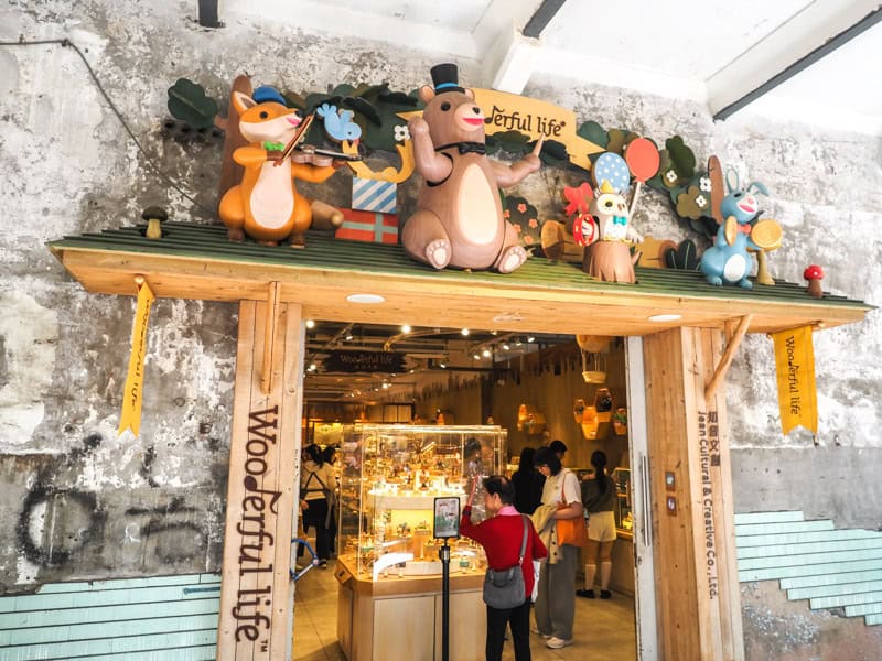 The entrance to Wooderful Life in Huashan, with several carved wooden animal characters above the doorway