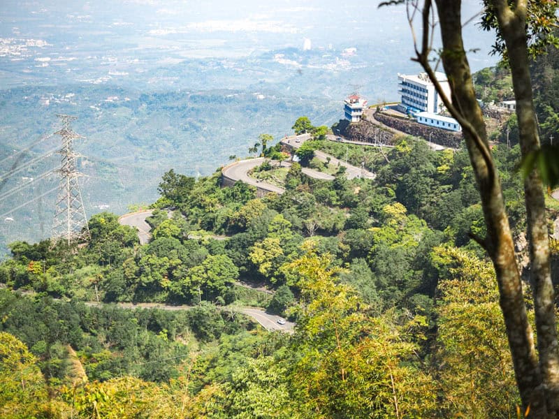 Some switchbacks on a highway shot from far away with a plain far below