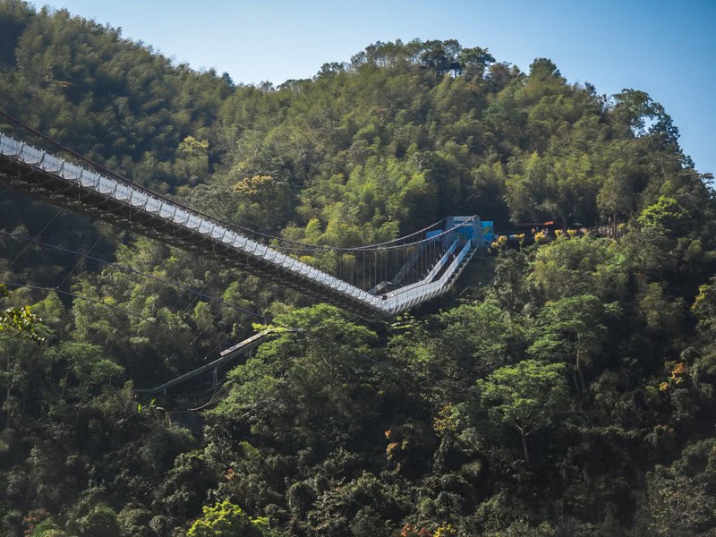 Half of Taiping Suspension Bridge viewed from a side angle as it connects to a mountain on the opposite side