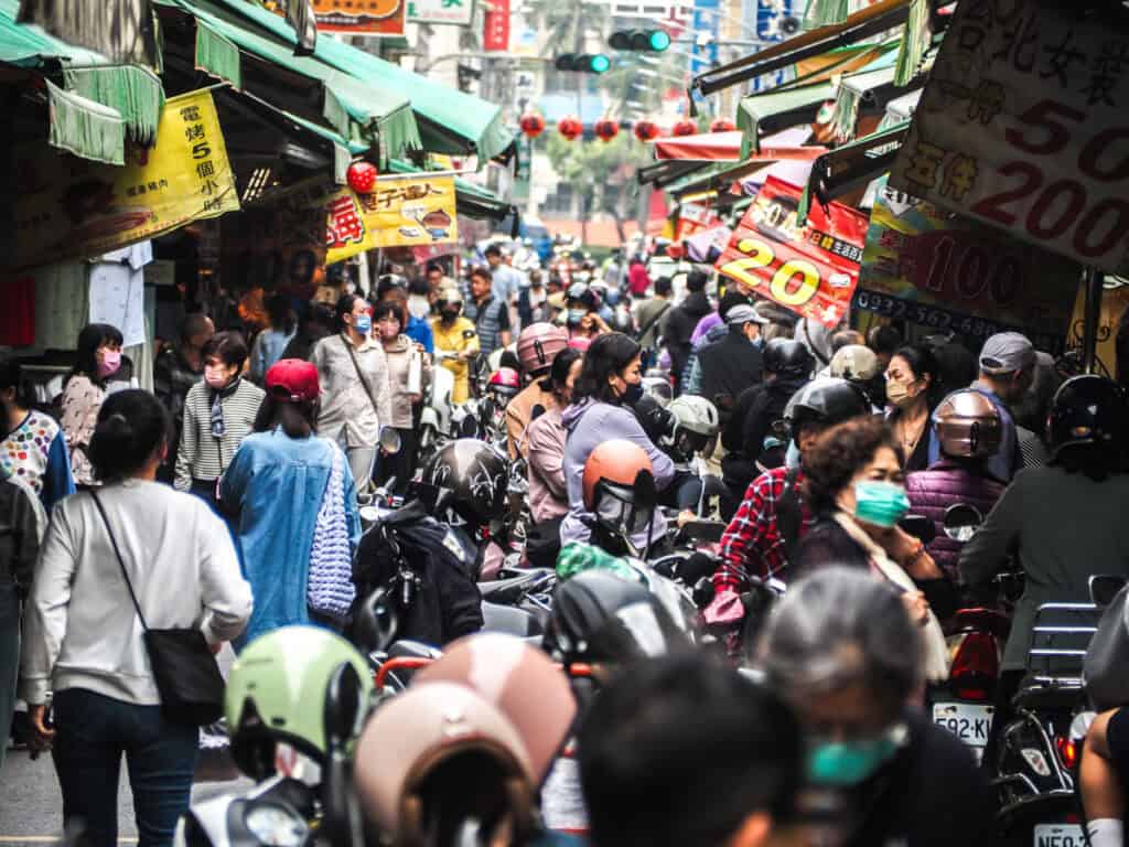 A thick crowd of people in a narrow lane of Sanmin Market in Kaohsiung