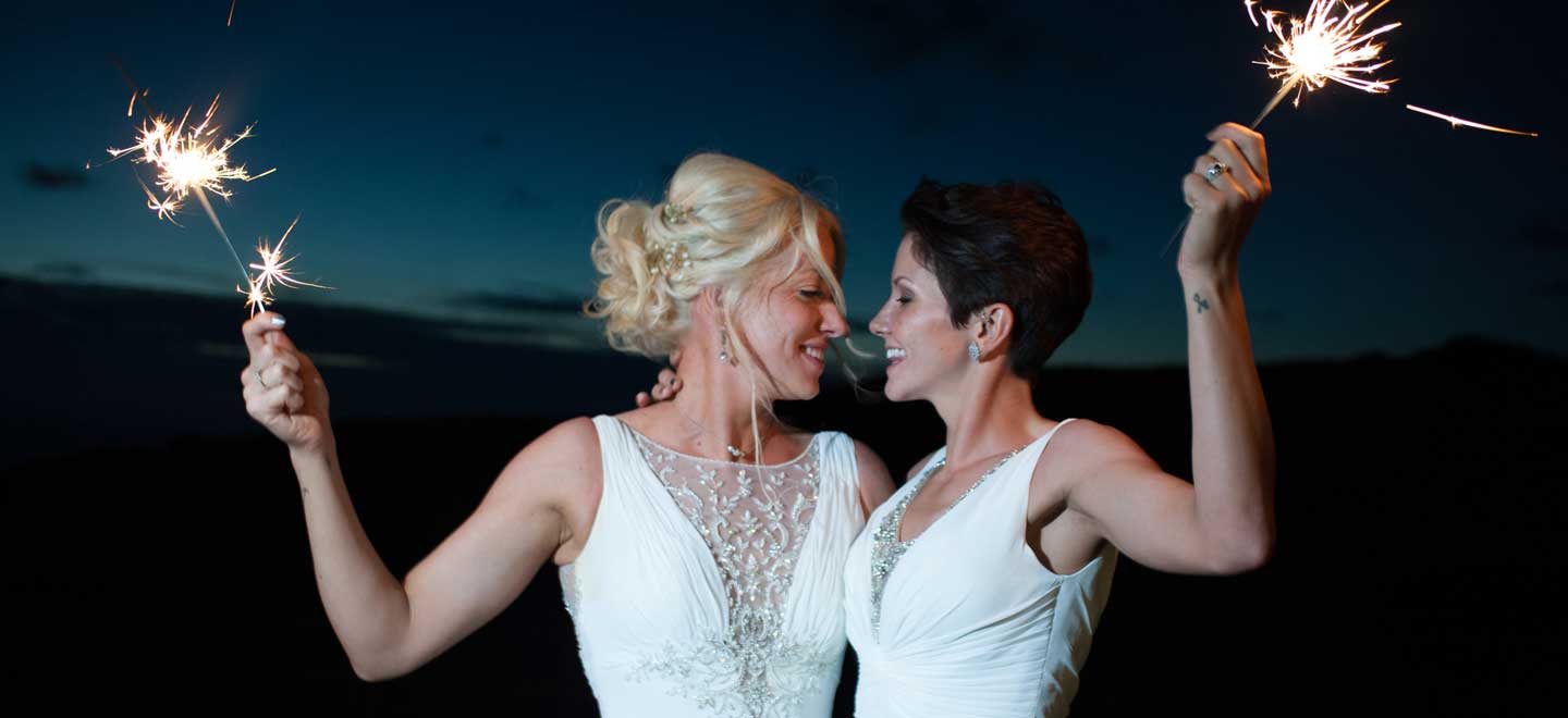 Brides Hold Sparklers At Lesbian Wedding Of Emma And Amy At Ocean Kave Image By Mrsjutsonphotography 1 4