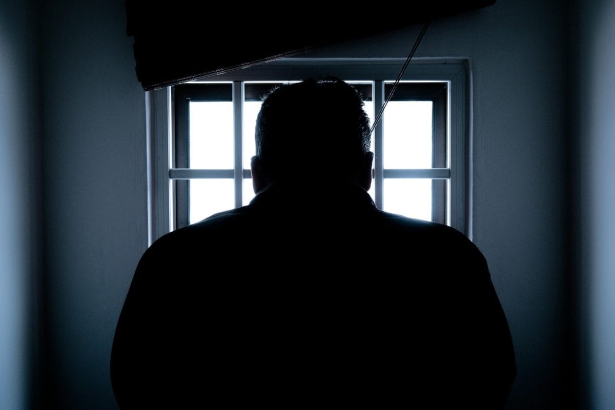Silhouette Of A Man In Window giving death penalty last rites.