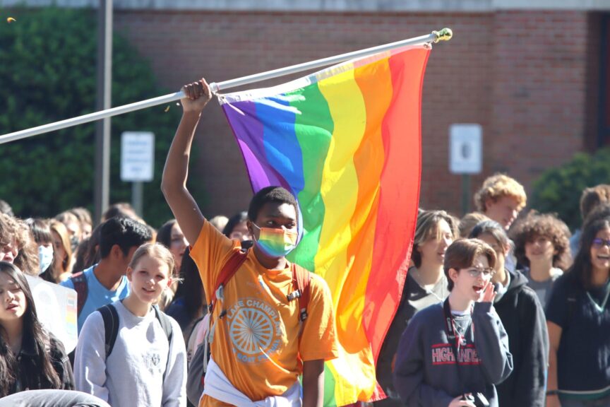 High school students across virginia including those at mclean high school walked out in protest of the governor’s revised transgender student policies on sept. 27, 2022. Pictured is a student holding a rainbow flag.