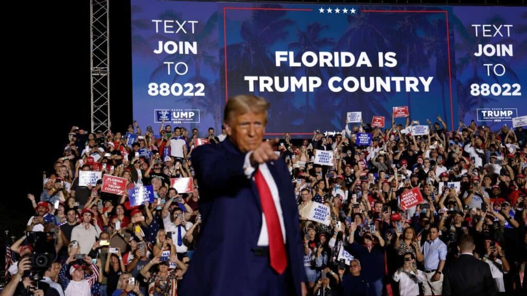 Elon musk is taking over while trump sits idly by. Donald trump pointing at supporters at a rally