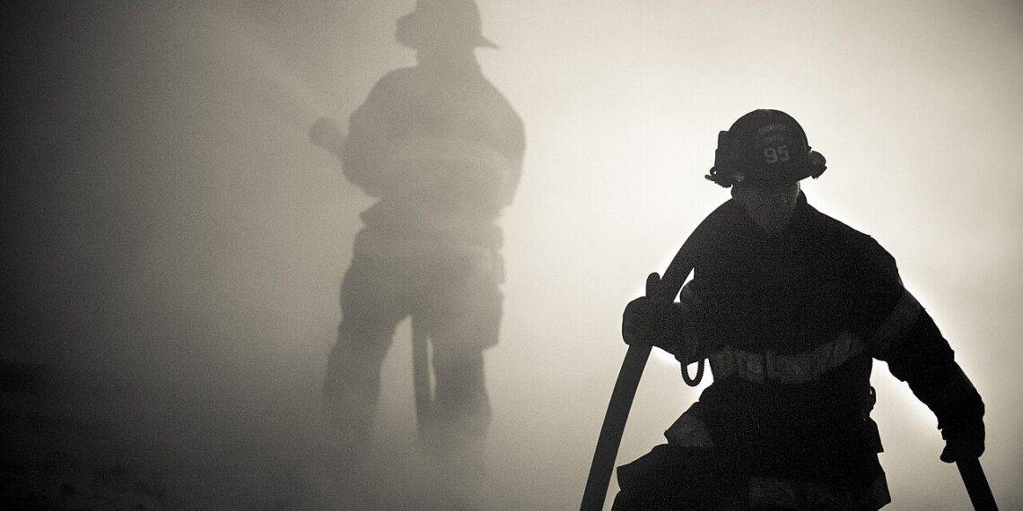 Firefighters surrounded by smoke
