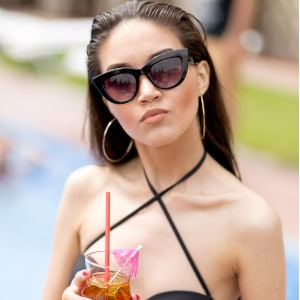 Client enjoying a fun and professional photo session in warsaw, wearing black swimwear and chic sunglasses.