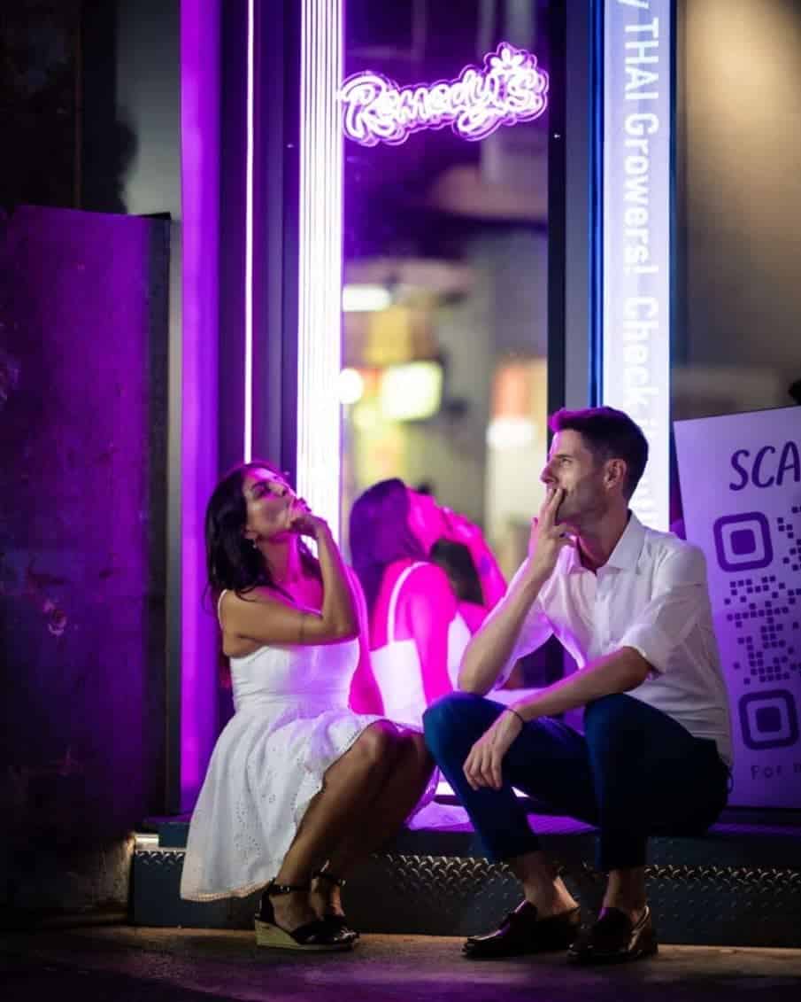 Para w świetle neonów podczas wieczornej sesji w mieście. Fotograf portret warszawa i profesjonalna fotografia par