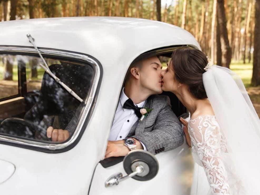 Intymny kadr: para młoda całująca się w zabytkowym aucie. Emocjonalny reportaż ślubny w plenerze.