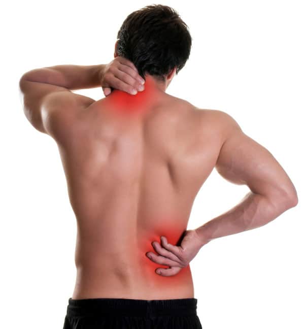 A man experiencing *Body Stress Release* by holding his back with his hand.