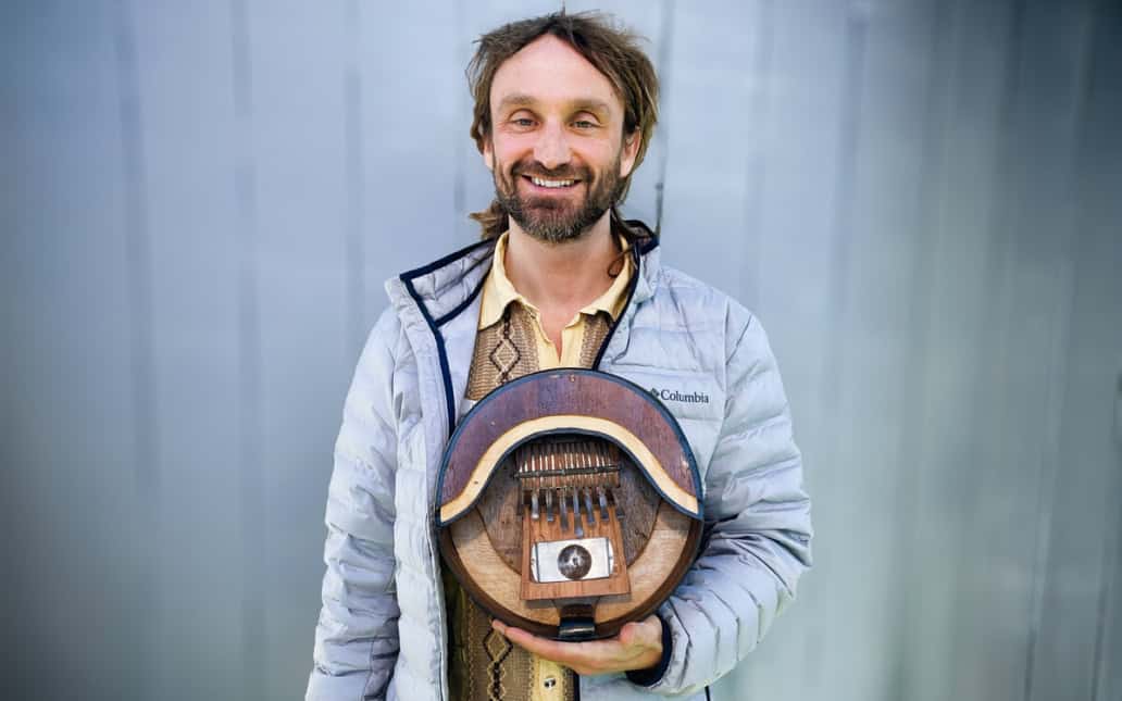 Image of Max Berry holding an mbira